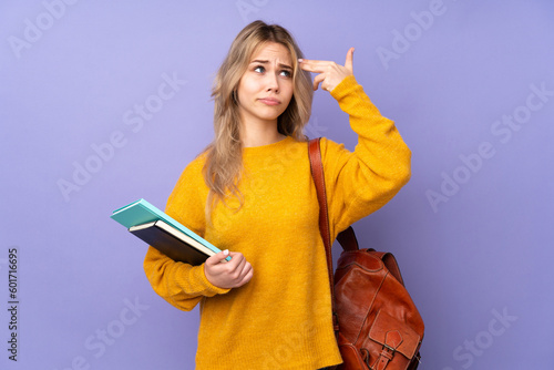 Teenager Russian student girl isolated on purple background with problems making suicide gesture