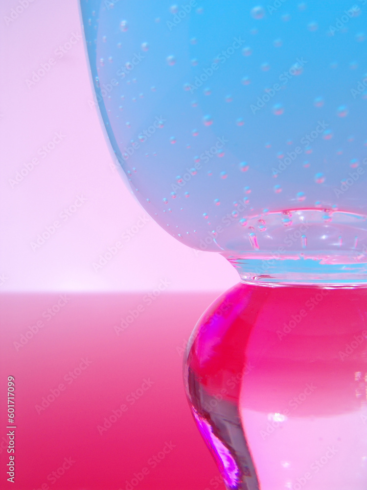 Close up of textured wine glass with colorful lighting Close up of textured wine glass with colorful lighting