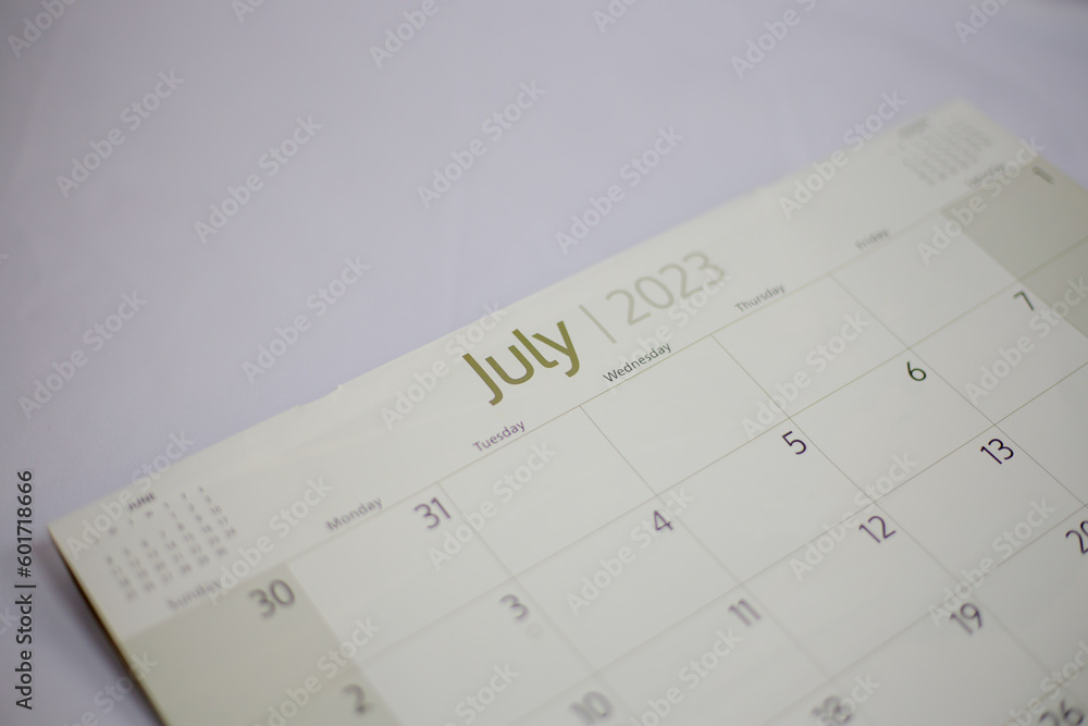 Selective focus shot of a closeup calendar of July 2023. June 2023 calendar isolated on background. Selective focus shot of a closeup calendar of July 2023. June 2023 calendar isolated on background.