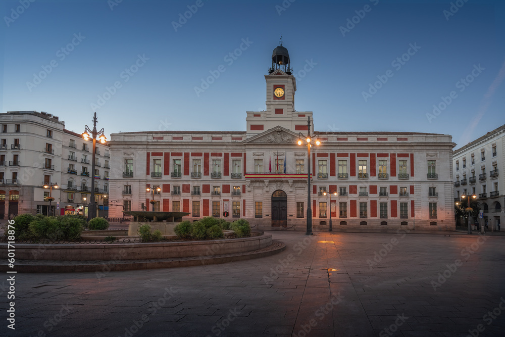 Naklejka premium Puerta del Sol Square at sunrise with Royal House of the Post Office (Real Casa de Correos) - Madrid, Spain