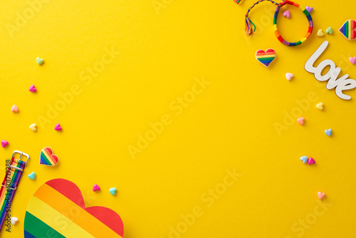 A top view flat lay of pride-themed accessories, including rainbow pins, wristle Fototapeta