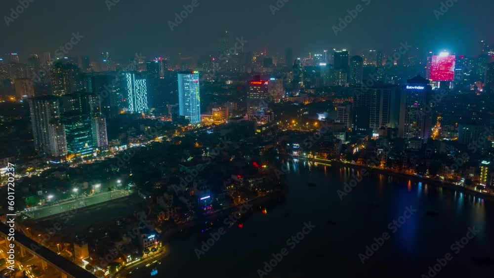 HANOI, VIETNAM - MAY, 2023: Night aerial drone view timelapse of a city streets in downtown nightlife traffic from a top view. HANOI, VIETNAM - MAY, 2023: Night aerial drone view timelapse of a city streets in downtown nightlife traffic from a top view.