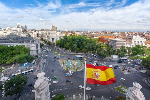 Aerial view of Calle de Alcala Street and Plaza de Cibeles with the Spanish Flag - Madrid, Spain photo