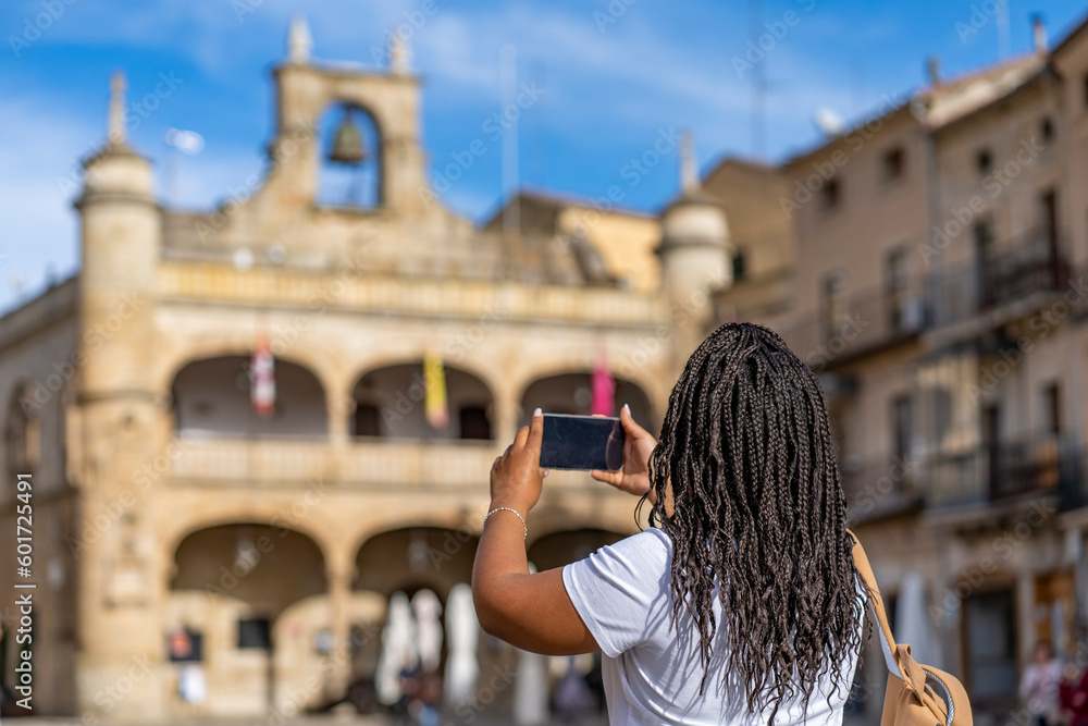 tourist woman on  holiday taking  photo with phone at famous village of Ciudad Rodrigo in Salamanca