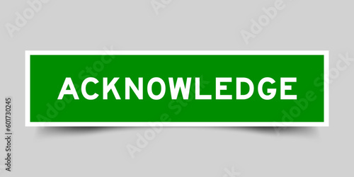 Sticker label with word acknowledge in green color on gray background