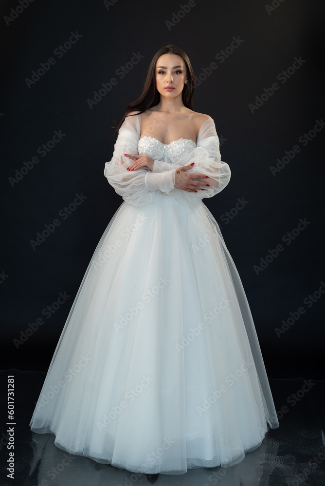 Fototapeta premium Perfect bride in wedding dress on black background