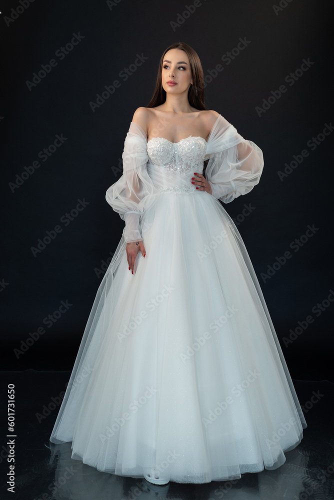 Fototapeta premium Perfect bride in wedding dress on black background