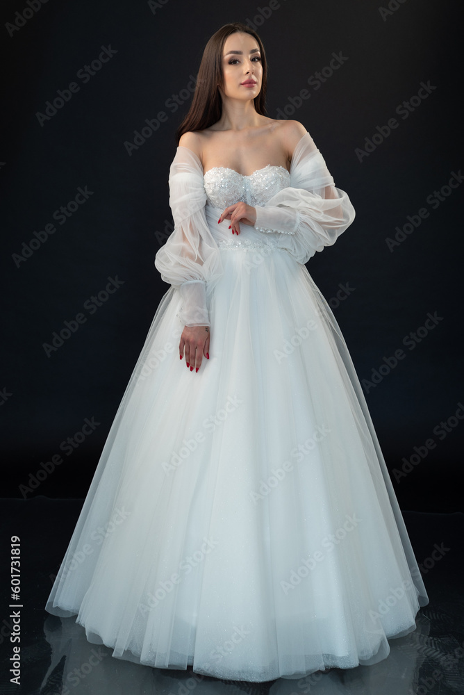 Fototapeta premium Perfect bride in wedding dress on black background