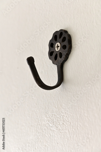Black metal wall hanger on white wall