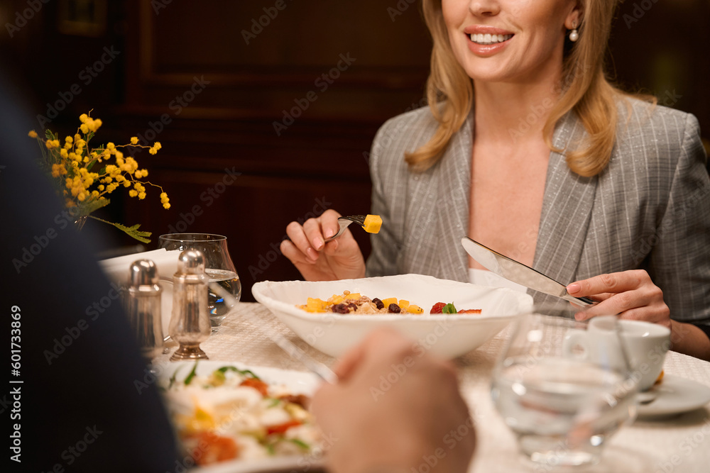 Woman enjoying meal and conversation with man Woman enjoying meal and conversation with man