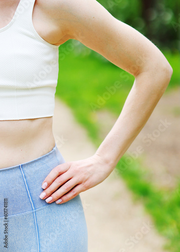 Close up slim sporty fitness young woman gymnast in sportswear training performs exercises outside. Sport motivation, physical education. 