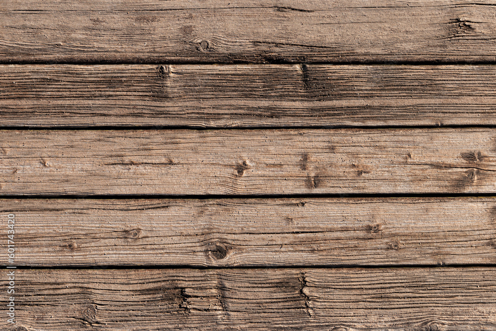 Raw wooden planks. Graphic effect pattern of a rustic desaturated timber board. Top view. Raw wooden planks. Graphic effect pattern of a rustic desaturated timber board. Top view.