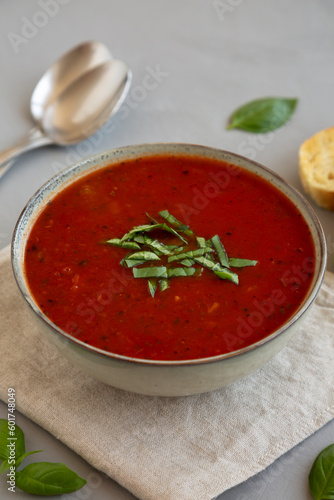 Homemade Tomato Basil Soup in a Bowl, side view. Close-up.