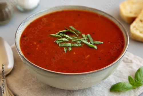 Homemade Tomato Basil Soup in a Bowl, low angle view. Close-up.