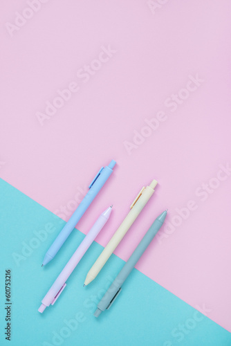 Set of pastel ballpoint pen on light pink and blue colors. Stationery background. Flatly, copyspace.