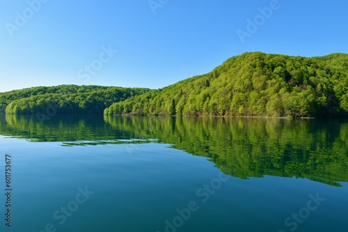 Forest covered hills above Kozjak lake and a reflection in the water at Plitvice lakes in Lika-Senj county, Croatia