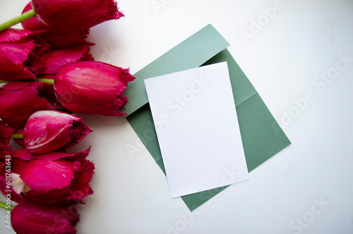 Greeting, postcard, birthday, wedding invite mock up white card with the bouquet of pink tulips