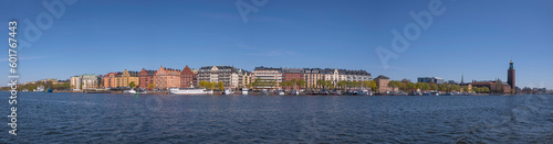 Waterfront apartment houses, steam, fishing and transport boats at the pier Norrmälarstrand, a sunny early summer day in Stockholm © Hans Baath