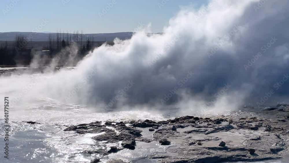 Iceland. Nature. Geyser Strokkur. Eruption. Strokkur is part of geothermal area. Fumaroles. Smoke over the ground. Beautiful geyser eruption on a sunny day. The most famous geyser. Iceland. Nature. Geyser Strokkur. Eruption. Strokkur is part of geothermal area. Fumaroles. Smoke over the ground. Beautiful geyser eruption on a sunny day. The most famous geyser.