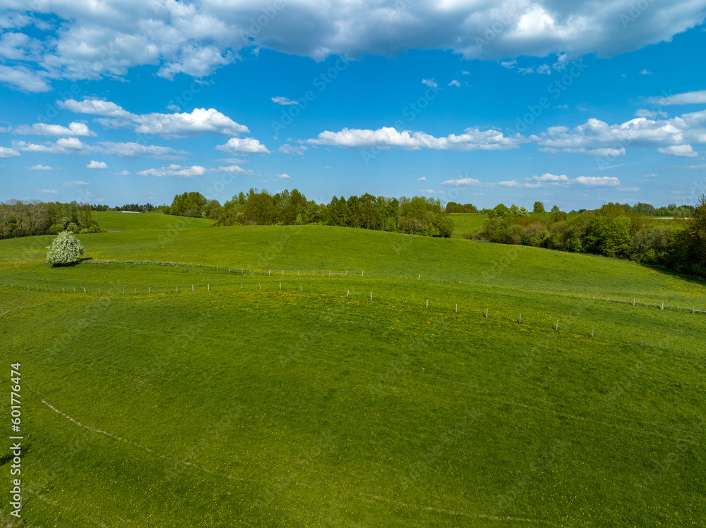 Aerial view of meadows and agricultural field in spring with blue sky, Poland, Mazury Aerial view of meadows and agricultural field in spring with blue sky, Poland, Mazury