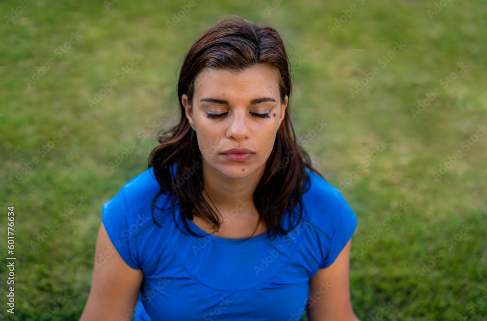 High angle view of latin woman meditating in the park High angle view of latin woman meditating in the park