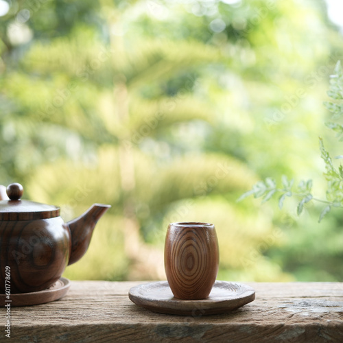 wooden small tea cup and earthenware pot on wooden table outdoor drinking