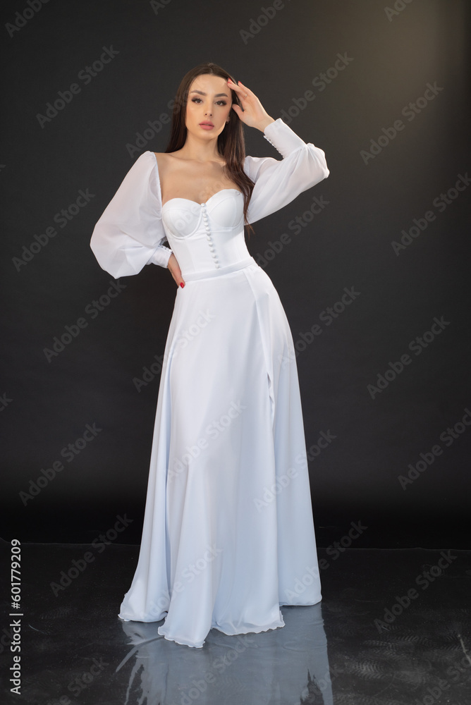 Stylish beautiful woman bride in wedding dress on black background Stylish beautiful woman bride in wedding dress on black background