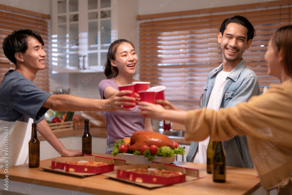 Group of Asian friends enjoying an evening party together at home.
Group of Asian friends enjoying an evening party together at home.