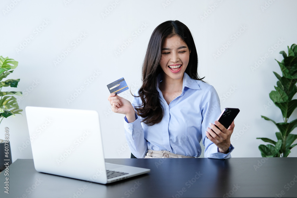 Young Woman Shopping with Credit Card and Laptop at Home, Happy Female Buying Products via Online Young Woman Shopping with Credit Card and Laptop at Home, Happy Female Buying Products via Online