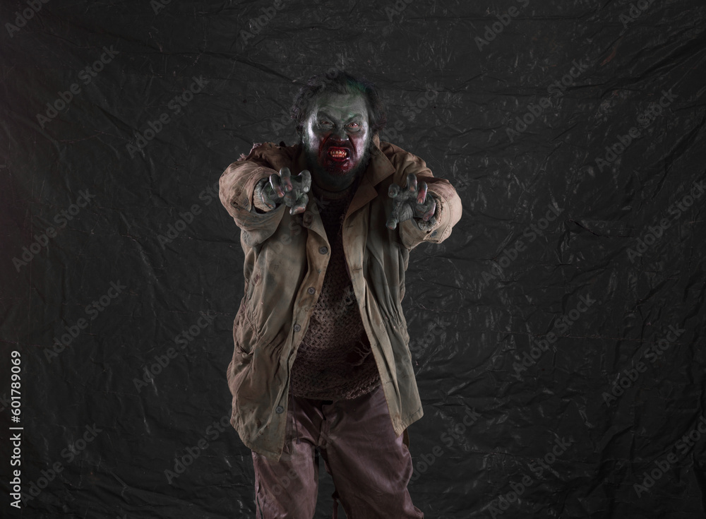 Angry bloody zombie man on dirty background Angry bloody zombie man on dirty background