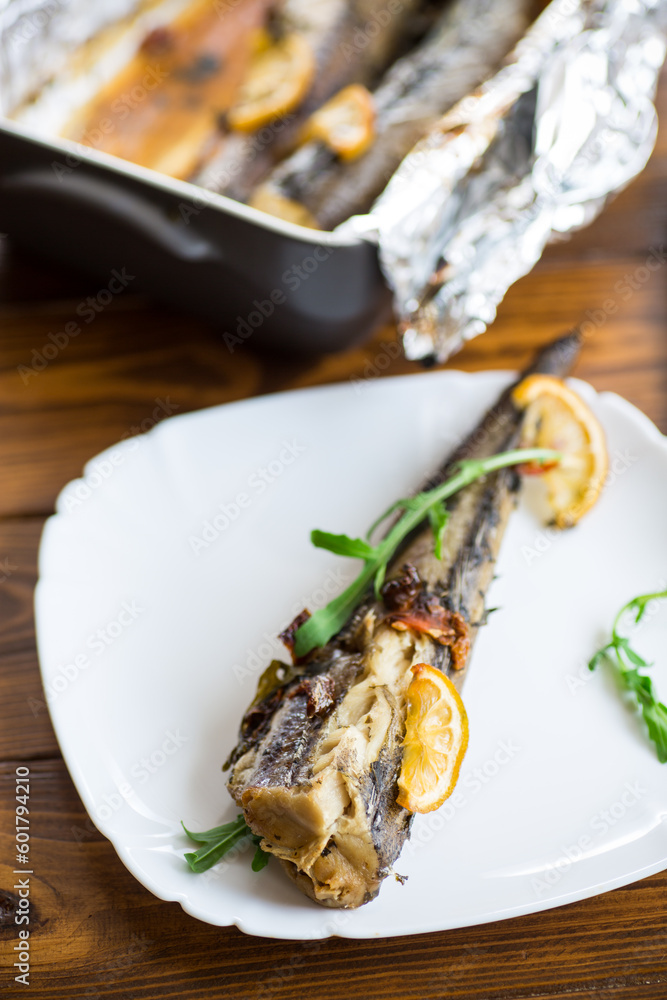 Baked fish with seasonings and spices in a plate Baked fish with seasonings and spices in a plate