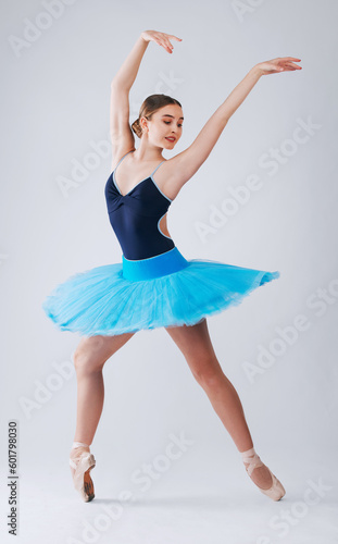 Ballet, creative dance and woman with talent, wellness and freedom with fitness and energy on grey studio background. Practice, female dancer and ballerina with formal training, performance and hobby
