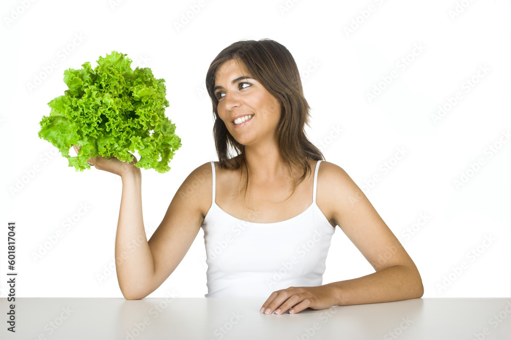 Gorgeous happy woman holding and looking to a lettuce Gorgeous happy woman holding and looking to a lettuce