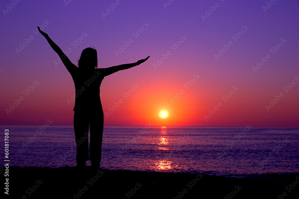 Woman silhouette at the sunset on a beautiful end of the day