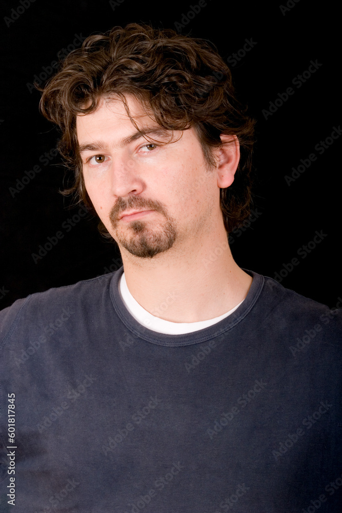 Portrait of a young man over black background. Portrait of a young man over black background.