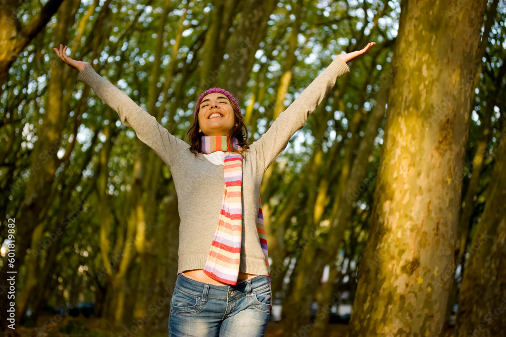 Beautiful happy young woman with open hands in the forest Beautiful happy young woman with open hands in the forest