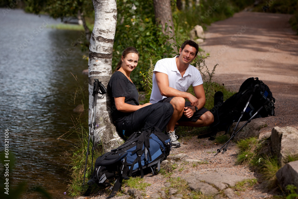 A couple taking a break while on a hiking camping trip