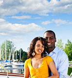 Portrait of young romantic couple standing at harbor with copyspace