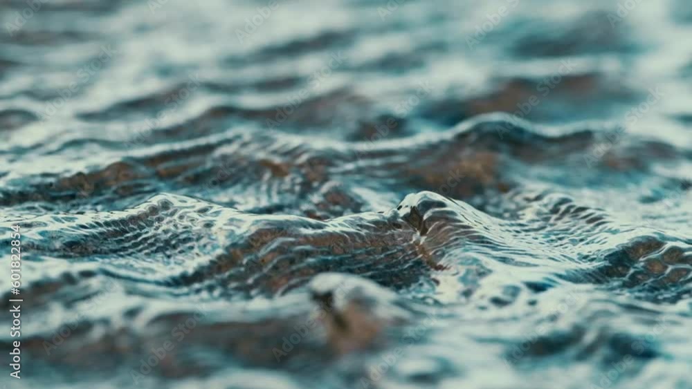 slowmo closeup of the surface of a little stream with reflecting water texture that repeats itself into the background