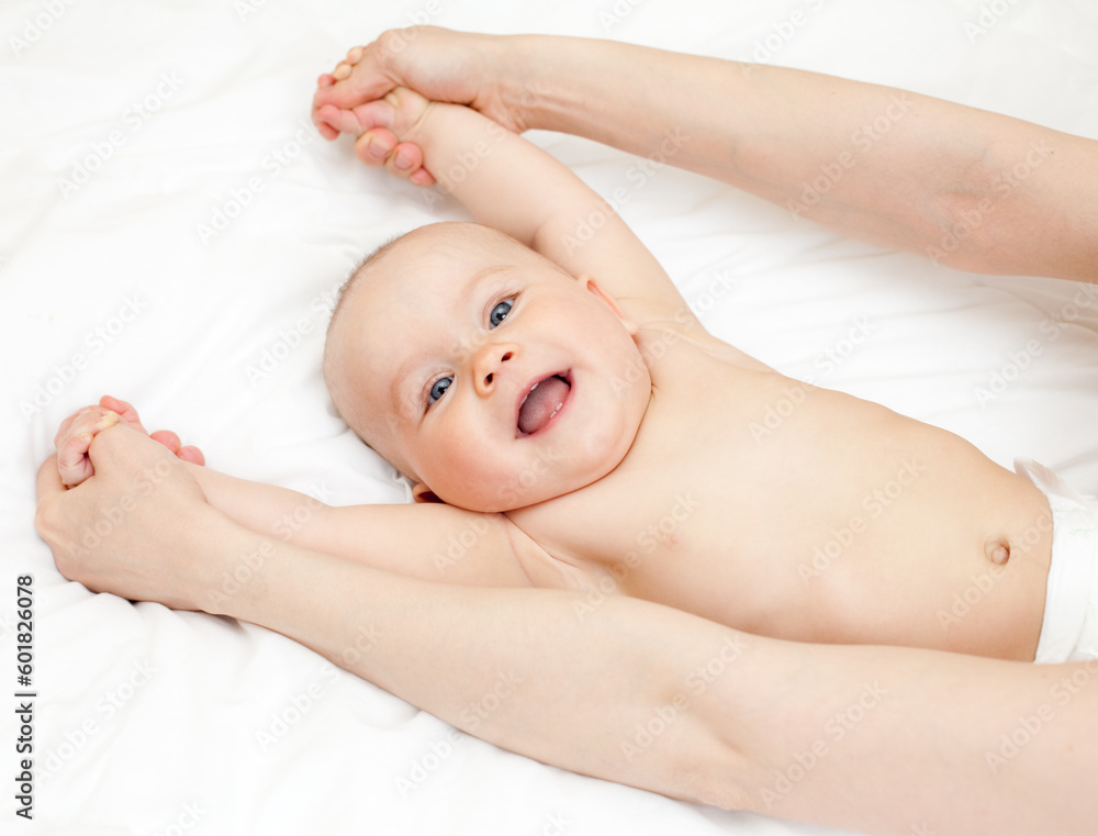 Mother massaging her child, shallow focus Mother massaging her child, shallow focus