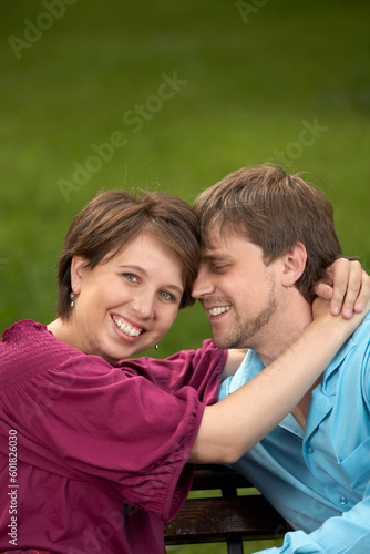 The happy couple embraces in a summer garden © Designpics