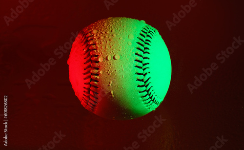 Red and green creative lighting on baseball with water droplets for rain game concept.
