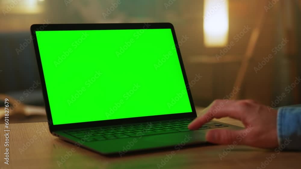 Man hands of freelancer use laptop with green screen. At home. Working. Scrolling through website. Typing Man hands of freelancer use laptop with green screen. At home. Working. Scrolling through website. Typing
