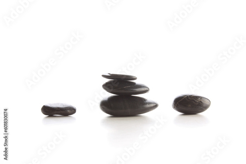 Isolated black massage spa stones on white surface