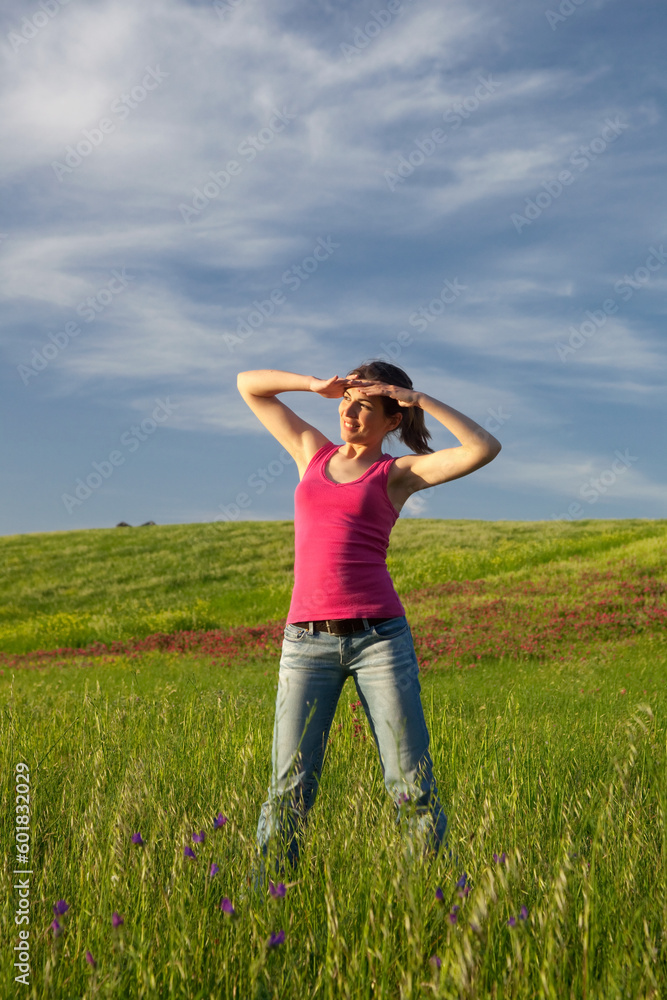 Beautiful young woman on the field looking away Beautiful young woman on the field looking away