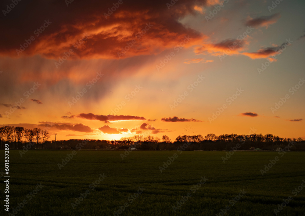colourful sunset over field 
- heavy cloud in golden hour 