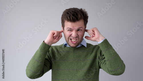 Photography The European young man covers his ears