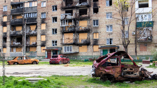 A broken Ukrainian civilian car, shot by artillery, stands in the courtyard of a destroyed house. War between Russia and Ukraine. The wreckage of an abandoned car.