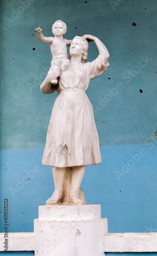 A statue of a mother and child that was damaged by shelling. A statue battered by rocket fragments stands at the bombed-out cultural center. War in Ukraine. Ukraine, Irpin - May 06, 2023.
