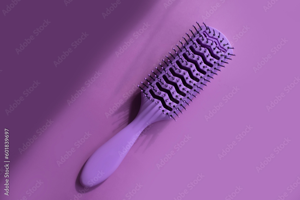 Hairbrush on colored background
